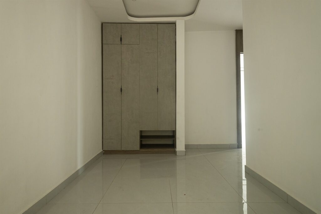 Brum Height 8: Unfurnished bedroom with a recessed ceiling